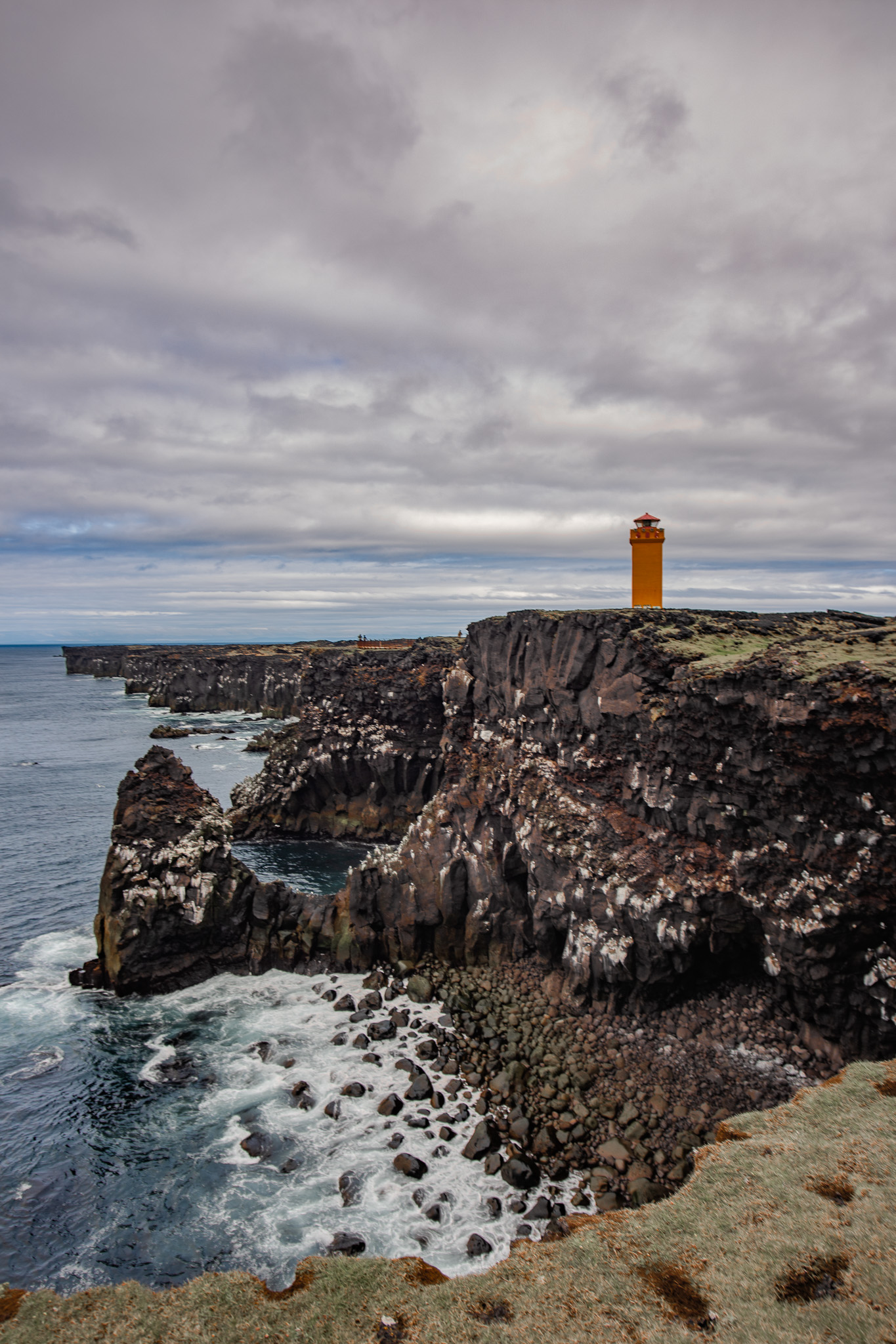 Orange lighthouse from the lava cliffs